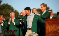Rory McIlroy dons the green jacket after winning his second Masters in a row, forcing Augusta National chairman Fred Ridley to do the honor usually given to the prior year's champion