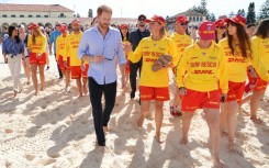Britain's Prince Harry and his wife meet with volunteer first responders at Bondi Beach in Sydney.