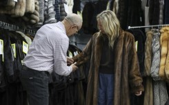 Owner of Madison Avenue Furs Larry Cowit assists a customer in his store, which has seen an uptick in interest in vintage fur in recent years