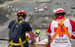 This handout picture released by the Mexican Red Cross shows the removal of the body of a Canadian woman who was shot dead at Teotihuacan by a man who later killed himself