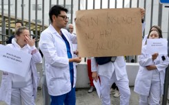 Doctors and nurses in Ecuador's capital protest dismissals in the state health care system