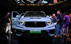 Visitors crowd around a Great Wall Motors sub-brand Tank 700 Hi4-Z at the Beijing Auto Show