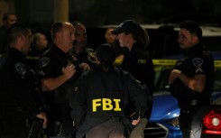 FBI agents are seen outside a residence associated with the alleged White House Correspondents' Dinner shooter in Torrance, California, on April 25, 2026