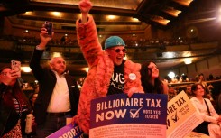 People chant in support of a tax on billionaires during a Bernie Sanders rally in Los Angeles in February
