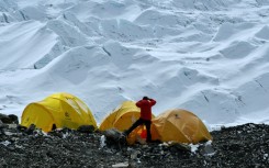 In 2021 photograph, a climber looks at the Khumbu icefall from Everest base camp