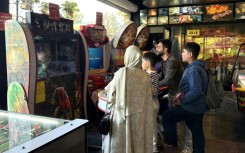 Iranians play games at an arcade in the capital. While some are trying to return to normal life under the ceasefire, others can't afford leisure activities