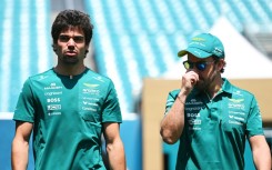 Good vibrations: Aston Martin drivers Lance Stroll and Fernando Alonso walk in the paddock before the Miami Grand Prix