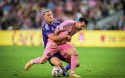 Inter Miami's Argentine forward, Lionel Messi, vies for the ball against Orlando City's Swedish defender Robin Jansson