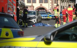 Members of the emergency services work at the scene where several people were injured during an incident involving a car in the city centre in Leipzig, eastern Germany