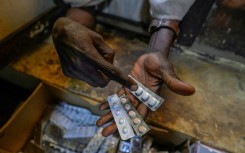 A person receives free medication in Sudan's capital. In Blue Nile to the south, displaced people have reported shortages of medicine and food