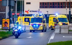 A convoy of ambulances believed to be carrying passengers evacuated from the cruise ship is escorted by Dutch police on motorcycles as it arrives at Leiden University Medical Center