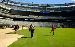 Pitch perfect: Workers install the pitch at New York New Jersey Stadium ahead of the 2026 FIFA World Cup