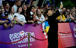 Austrian singer Johannes Pietsch, aka JJ poses on the turquoise carpet for the opening ceremony of the Eurovision Song Contest 2026 at the City Hall Square in Vienna, Austria