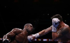 Daniel Dubois (L) takes a punch from champion Oleksandr Usyk during an undisputed world heavyweight title bout at London's Wembley Stadium in July last year