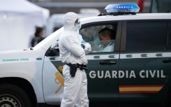A Spanish civil guard wears a protective suit as the MV Hondius arrived at the industrial port of Granadilla de Abona on Tenerife on May 10, 2026