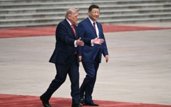 US President Donald Trump (L) takes part in a welcome ceremony with China's President Xi Jinping at the Great Hall of the People in Beijing