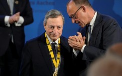 German Chancellor Friedrich Merz, rights, congratulates former European Central Bank president Mario Draghi on winning the 2026 Charlemagne Prize