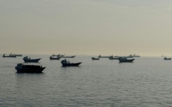 Vessels are seen anchored in the Strait of Hormuz, off the port city of Khasab on Oman's northern Musandam Peninsula on May 17, 2026