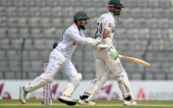 Bangladesh's Litton Das (L) celebrates after the dismissal of Pakistan captain Shan Masood (R)