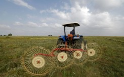 A farmer uses a hay-collecting machine in a field in the Zehiliga region of Morocco. Rising fertiliser costs are threatening the livelihoods of many farmers
