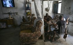 Havana residents play dominoes to pass the time amid frequent Cuban blackouts and the looming threat of US invasion