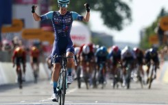 Alec Segaert celebrates as he crosses the line just ahead of the chasing pack