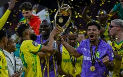 Keanu Cupido (L) and captain Ronwen Williams hold the CAF Champions League trophy after winning the final against FAR Rabat.