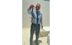 US Secretary of Health Robert F. Kennedy Jr. grabs two snakes with his bare hands, the latest example of his adventures involving animals
