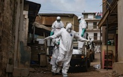 A Ugandan Red Cross worker during the evacuation of the body of a suspected Ebola victim in Kampala on May 26