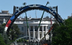 Crews work to build a mixed martial arts arena on the South Lawn of the White House for an upcoming fight that US President Donald Trump is staging as part of celebrations for the country's 250th anniversary