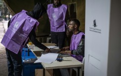 National Election Board of Ethiopia (NEBE) officials prepare voting materials ahead of the start of voting in Addis Ababa