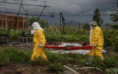 Medical staff carry an Ebola patient on a stretcher at Rwampara hospital in DR Congo