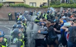 Protesters and police clash at UK rally over student murder