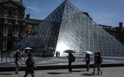 The record spring heatwave in France left tourists at the Louvre sheltering from the sun under umbrellas