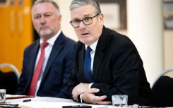 Britain's Prime Minister Keir Starmer (R) has clashed with Elon Musk previously