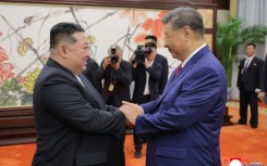 (FILES) This picture taken on September 4, 2025 and released from North Korea's official Korean Central News Agency (KCNA) on September 5, 2025 shows North Korean leader Kim Jong Un (L) shaking hands with Chinese President Xi Jinping in Beijing