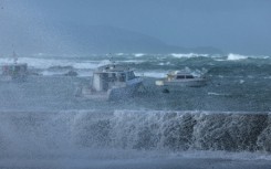 Stormy seas pound the coastline of Island Bay, a suburb of the New Zealand capital Wellington