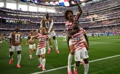 United States striker Folarin Balogun celebrates with team-mates after scoring in the World Cup co-hosts victory over Paraguay