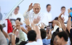 Pope Leo XIV greets the crowd as he arrives to attend a prayer vigil at the Olympic Stadium in Barcelona on June 9