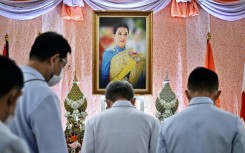 Well-wishers bow in front of an image of Thailand's Princess Bajrakitiyabha Mahidol, at Chulalongkorn Hospital in Bangkok
