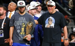 Jalen Brunson of the New York Knicks accepted the Bill Russell NBA Finals Most Valuable Player Award trophy with his father at his side