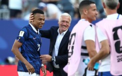 France coach Didier Deschamps congratulates Kylian Mbappe, who scored twice in his team's 3-1 win over Senegal on Tuesday at the World Cup