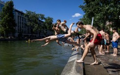 Young people dived into the Canal Saint-Martin in Paris to beat the heat