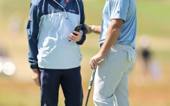 World number two Rory McIlroy, right, speaks with coach Phil Kenyon during a practice round ahead of the 126th US Open at Shinnecock