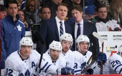Jim Hiller, left center standing, was named the new head coach of the NHL Toronto Maple Leafs by the club, for which he was formerly an assistant coach