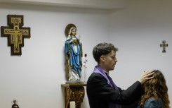 Self-proclaimed priest Francisco Marques lays his hands on a woman during an exorcism retreat in Portugal