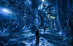 Attendees interact with immersive visualizations from the inaugural exhibition Machine Dreams: Rainforest are projected at DATALAND, the Museum of AI Arts