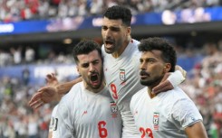 Iran players celebrate after scoring during their first World Cup match, a 2-2 draw against New Zealand in Los Angeles