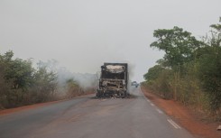 A burned truck is seen abandoned in the middle of the road leading to Sikasso, Mali in May 2026