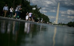 People walk near the Lincoln Memorial Reflecting Pool following the completion of recent renovations in Washington, DC